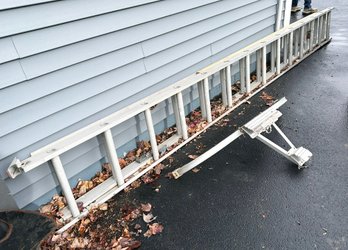 A 24' Aluminum Extension Ladder And Support Bar