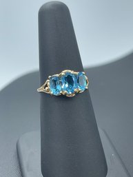 Impressive 3 Stone Blue Topaz Ring In 10k Yellow Gold