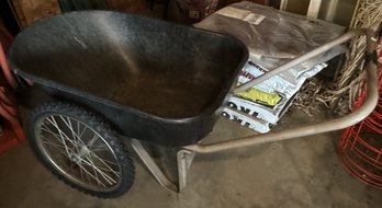 A GARDEN SPREADER AND A WHEELBARROW