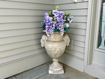 A Large Concrete Rams Head Design Urn With Faux Wisteria Flowers