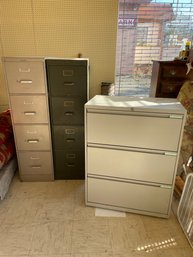 Three Metal File Cabinets.