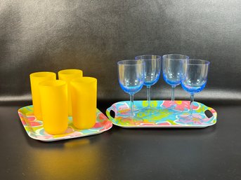 A Pair Of Plastic Trays With A Tropical Flower Motif, Plastic Stemware & Plastic Tumblers