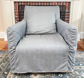 A Slip Covered Upholstered Chair In Grey Linen