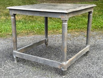 A Carved Oak End Table With Inset Metal Trim