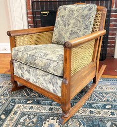 A Late 19th Century Carved Mahogany Cane Back Rocking Chair With Carved Chrysanthemum Details