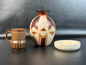 A Grouping Of Ceramics In Earth Tones: Vase, Mug & More