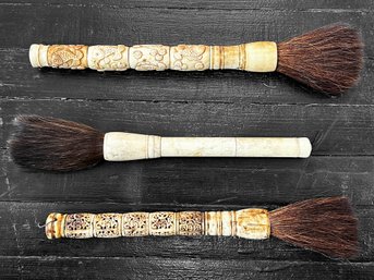 A Trio Of Carved Bone Handled Brushes