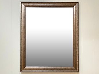 A Beveled Mirror In Faux Distressed Rose Gold Frame