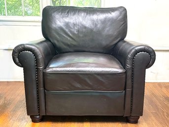 A Chocolate Leather Arm Chair With Nailhead Trim