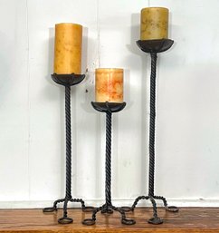 A Trio Of Large Wrought Iron Candlesticks