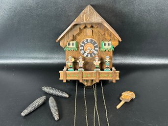 A Traditional German Cuckoo Clock With Little Musicians & Pinecone Weights