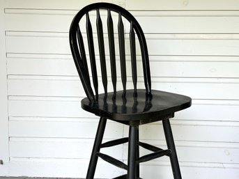 A Counter-Height Swivel Stool In Black