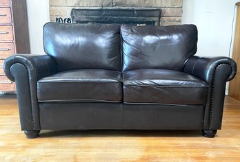 A Vintage Leather Love Seat With Nail Head Trim