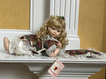 A Kinnex Porcelain Doll With Pillow