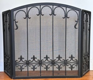 A Wrought Iron And Mesh Fireplace Screen