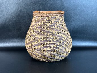 A Vintage Handwoven Basket With An Attractive Pattern