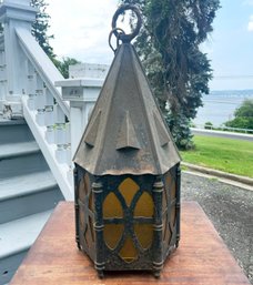 An Antique Lantern Fixture With Amber Glass