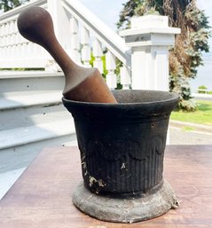 An Antique Cast Iron Mortar And Wood Pestle