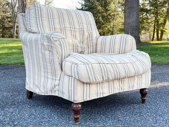 A Comfortable Custom Rolled Arm Chair With Down Cushions In Muted Striped Linen