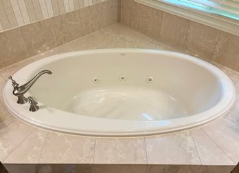 A Kohler Bath Tub And Brushed Steel Fittings