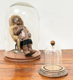 An Eskimo Doll Under A Glass Cloche