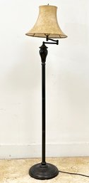 A Bronze Floor Lamp With Articulating Arm