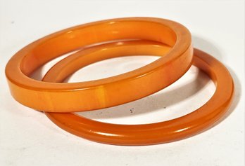 Two Vintage Orange Bakelite Plastic Bangle Bracelets