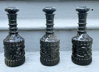 A Trio Of Antique Black Glass Bottles