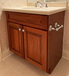 A Bathroom Vanity With Solid Maple Cabinetry, A Corian Top, And A Kohler Sink And Fittings