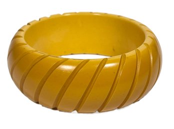 Wide Carved Bakelite  Yellow Bangle Bracelet Spiral Optic`