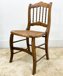 An Antique Spindle Back Side Chair With Cane Seat