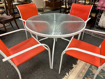 Round White Patio Table With 4 Red And White Chairs