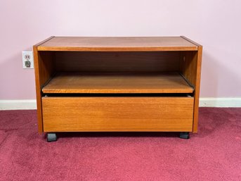 A Rolling TV Cart In Teak Veneer With A Pull-Out Shelf & Lower Drawer