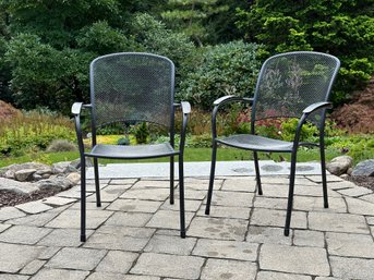 A Pair Of Stackable Outdoor Chairs In Mesh Metal