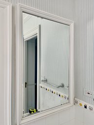 A Wood Framed Beveled Mirror Medicine Cabinet