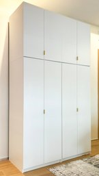 A Pair Of Modern Composite Cabinets With Brass Hardware By CB2