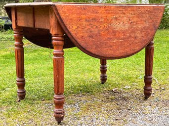 An Early 20th Century Turned Oak Drop Leaf Dining Table