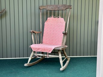 A Traditional Vintage Rocking Chair In Wood With A Naturally-Weathered Patina