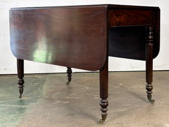 A Beautiful Antique Flame Mahogany Drop Leaf Dining Table