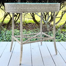 An Antique Wicker Console With Glass Top