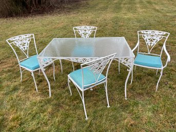 Five Piece Set Of Vintage Wrought Iron, Four Chairs And A Glass Top Table With Rose Motif.