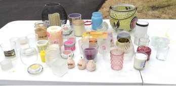 A Large Assortment Of Votive Style Candle Holders And A Few Larger Ones Too