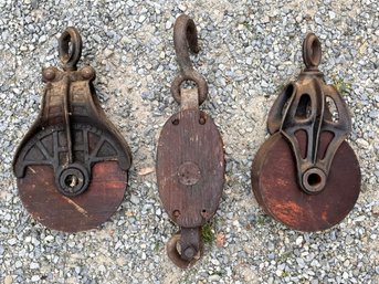 A Trio Of Antique Cast Iron And Wood Pulleys