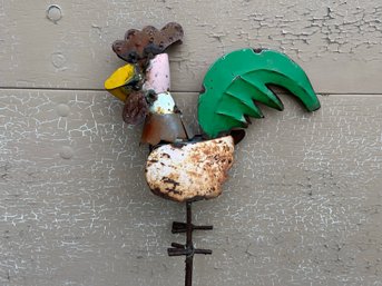 Garden Decor: A Colorful Metal Rooster On A Metal Spike