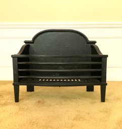 A Cast Iron Fire Basket With White Pine Logs