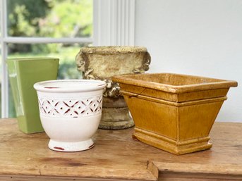 An Assortment Of Ceramic Cache Pots Or Planters