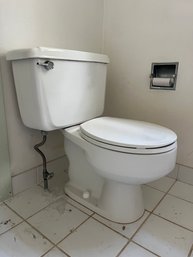 An American Standard 2 Piece Toilet - Laundry Room