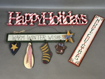 A Selection Of Festive Holiday Wall Signs In Wood
