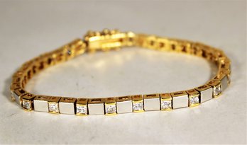 Gold And Silver Sterling Silver Tennis Bracelet Having Square White Stones