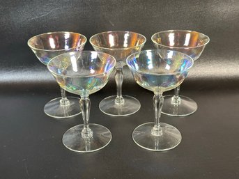 A Set Of Iridescent Stemware Coupes